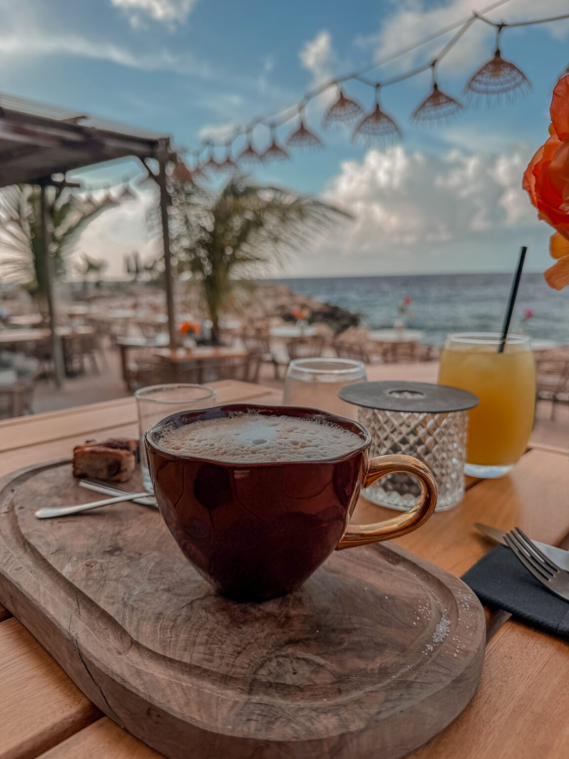 Coffee beside a calm coastal view